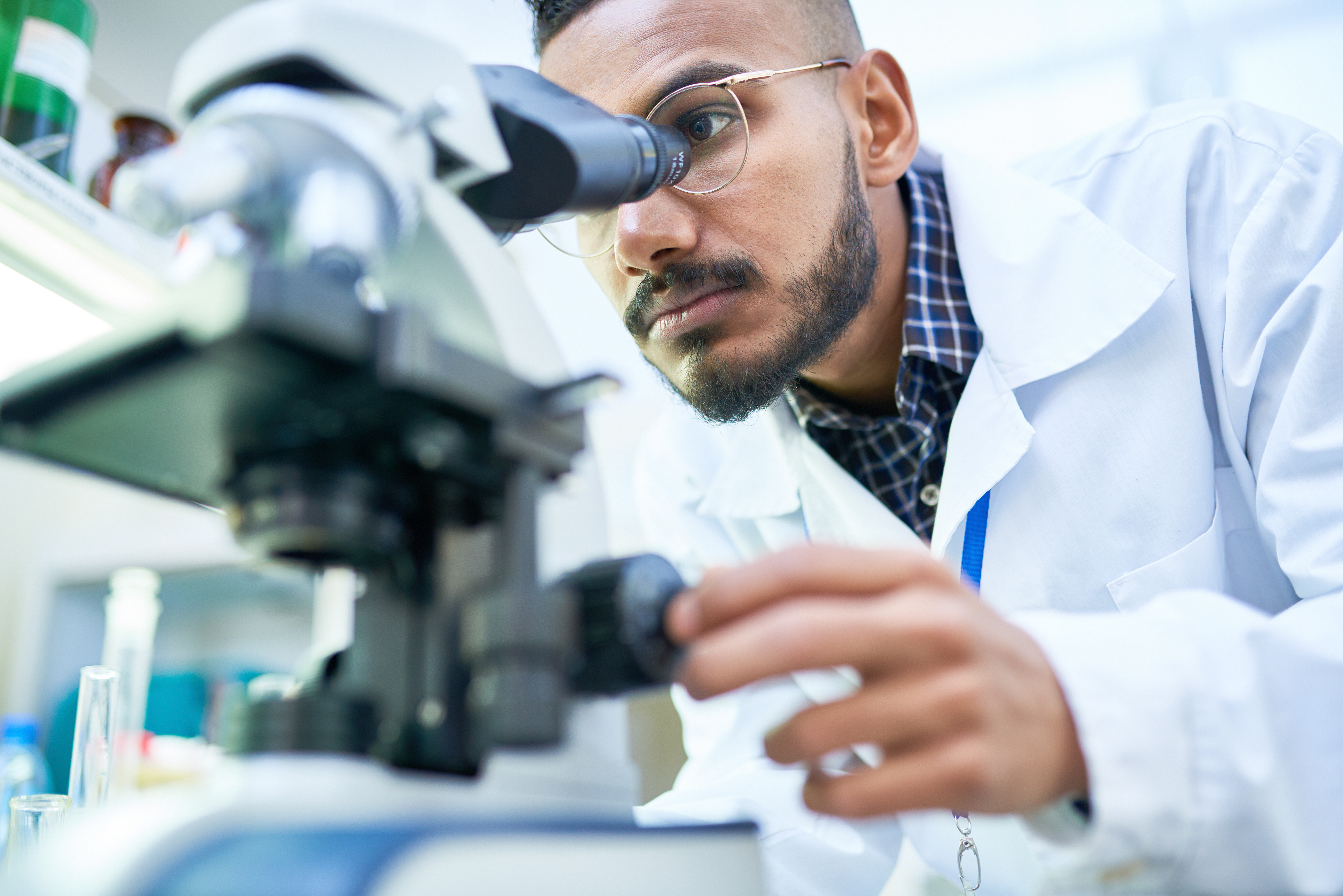 Male scientist at microscope