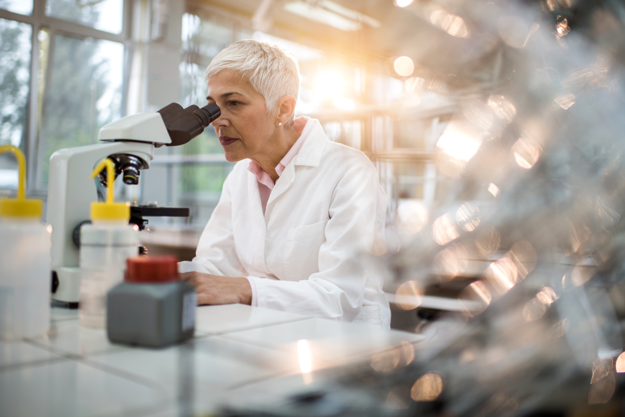 A picture of a researcher looking through a microscope in a laboratory